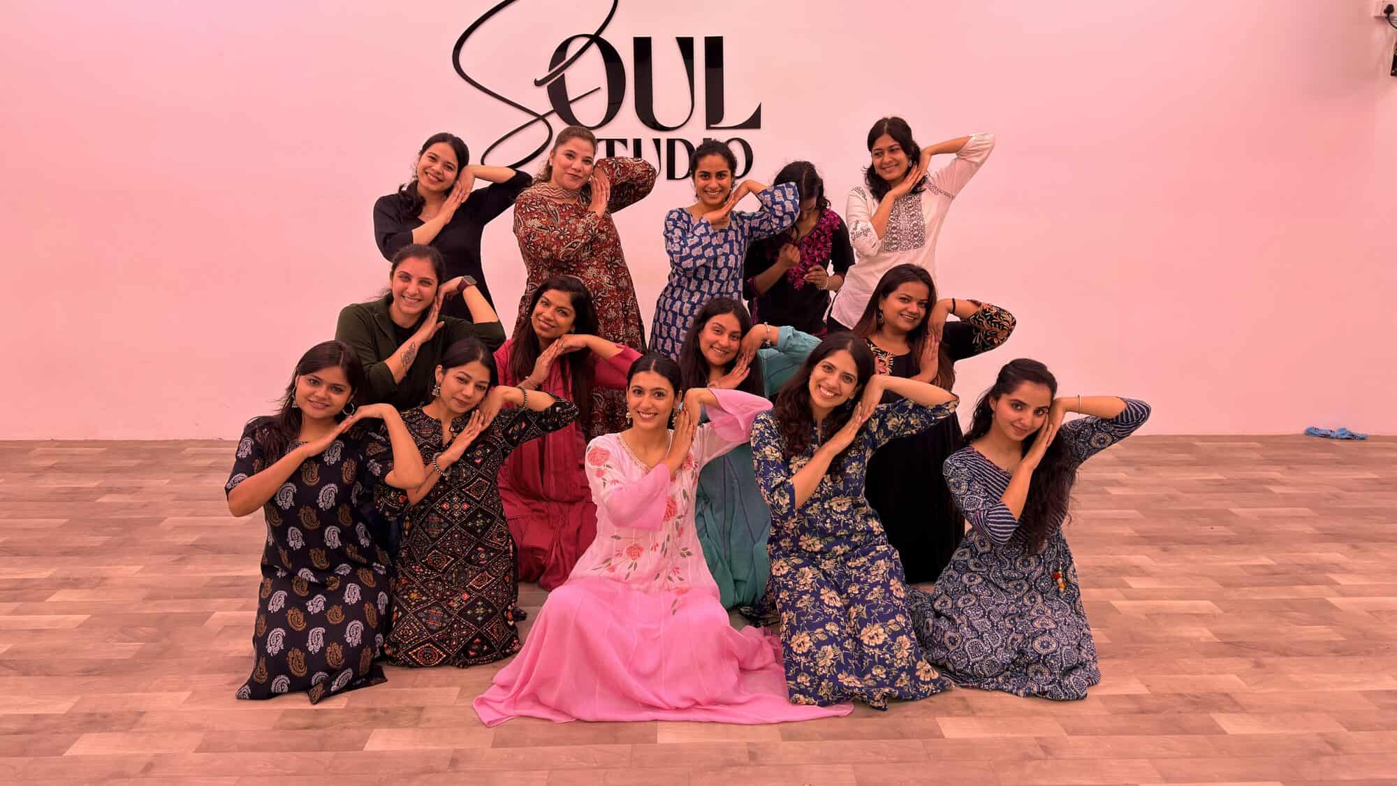 A workshop group in costume, posed together on the studio floor